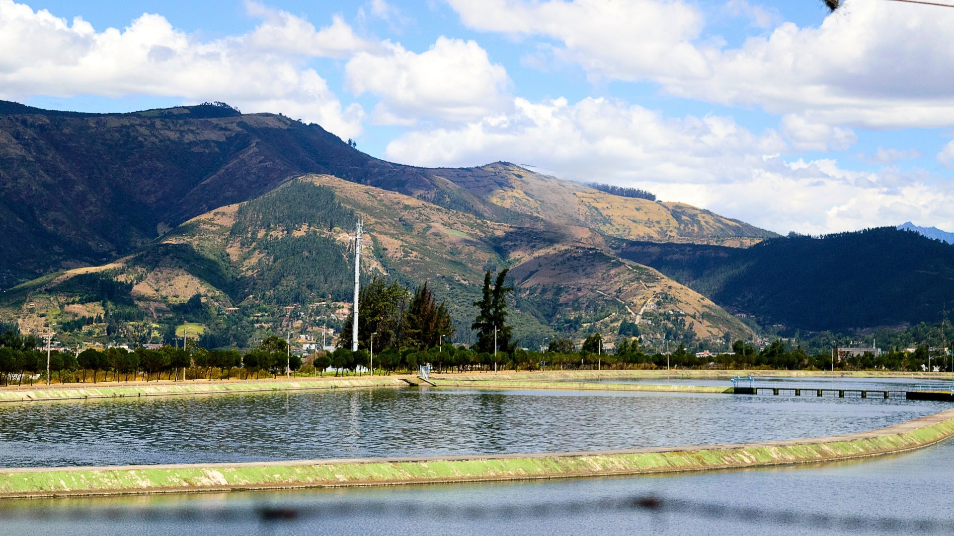 Water surrounded by trees and mountains